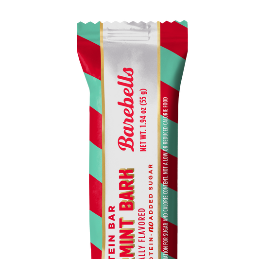 Barebells Peppermint Bark protein bar wrapped in white, red and mint green striped packaging