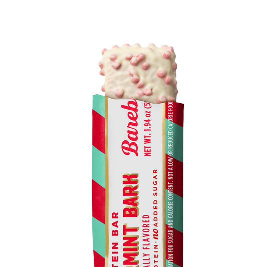 Barebells Peppermint Bark protein bar with white chocolate coating studded with pink peppermint pieces
