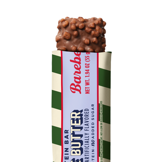 Barebells Cookie Butter protein bar with chocolate coating and crispy topping, partially unwrapped to show the bar inside green and cream striped packaging