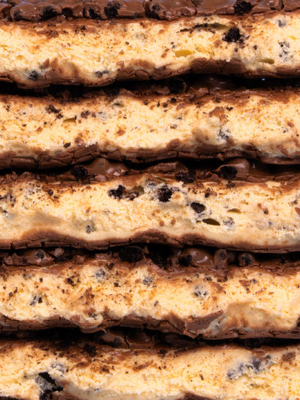 Stacked Barebells Cookie Captain protein bars showing layers of cookie dough and chocolate coating with cookie pieces